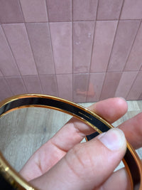 Bracelet jonc hermès doré et noir 23/06